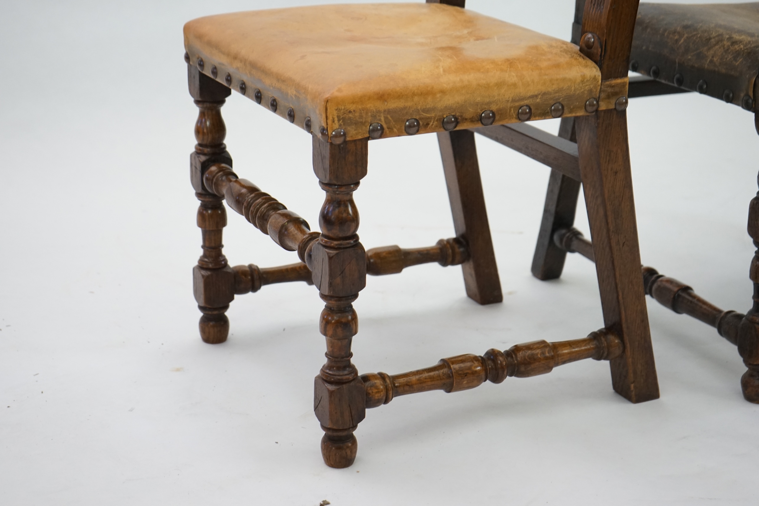 A set of fourteen 17th century style oak dining chairs including a pair of carvers